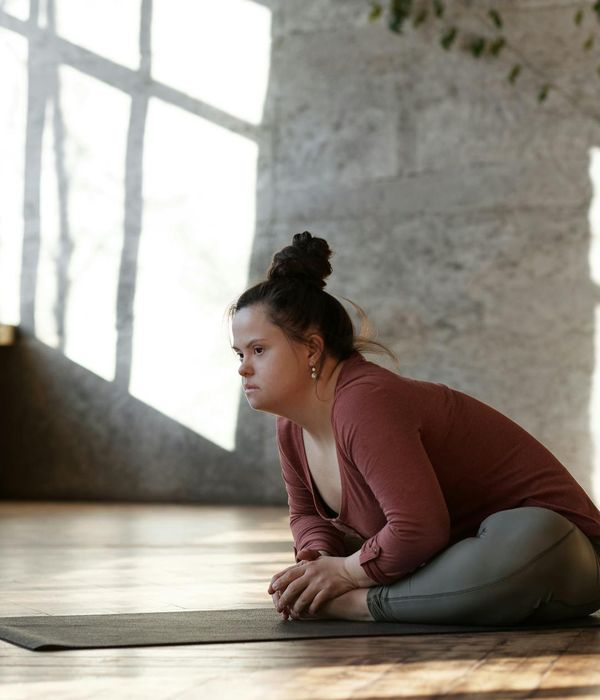 Person practicing gentle yoga poses in a quiet room